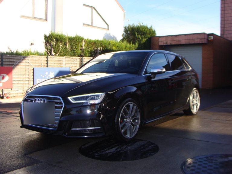 Une Audi S3 noire devant le garage